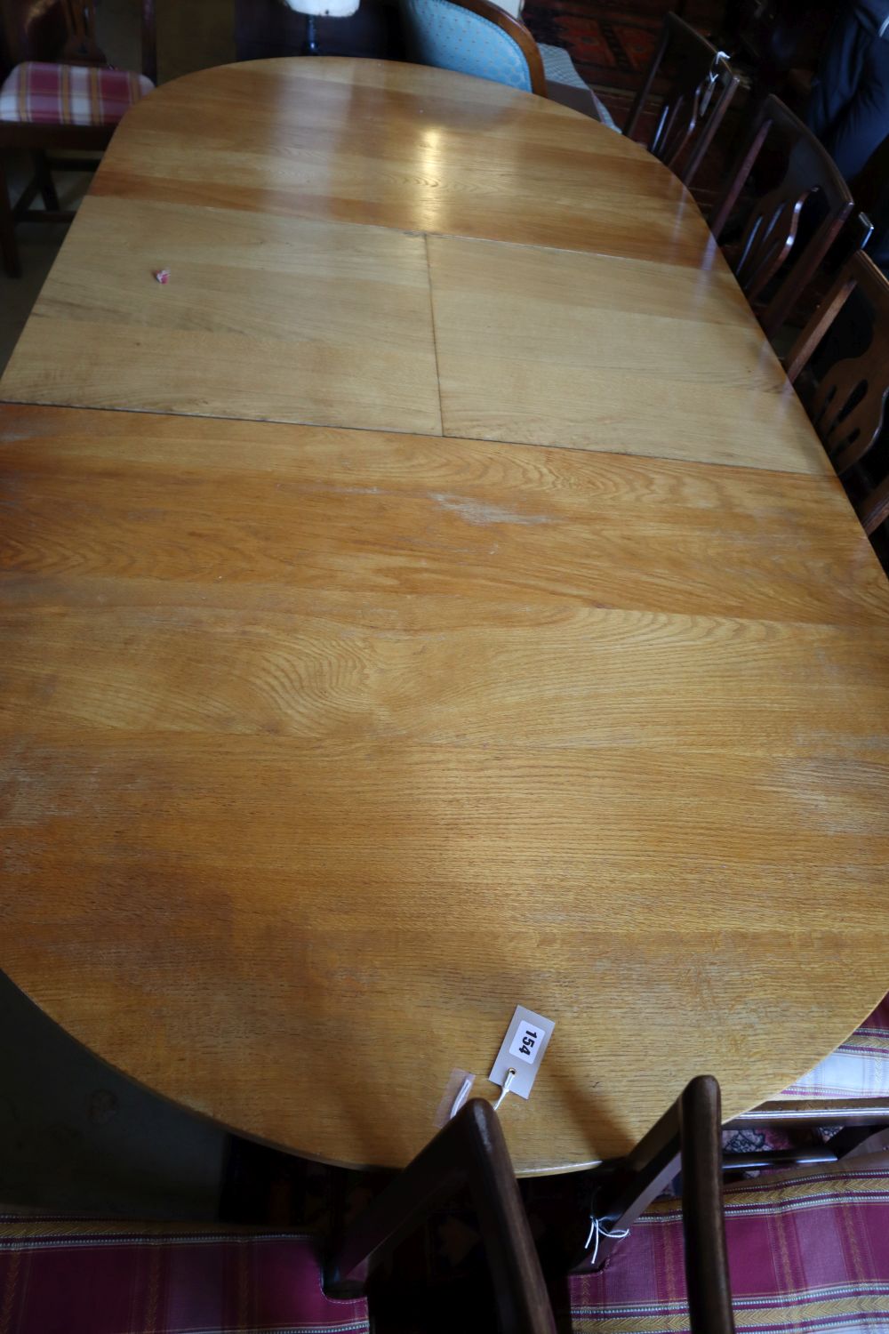 A contemporary oak extending dining table, length 240cm extended, depth 120cm, height